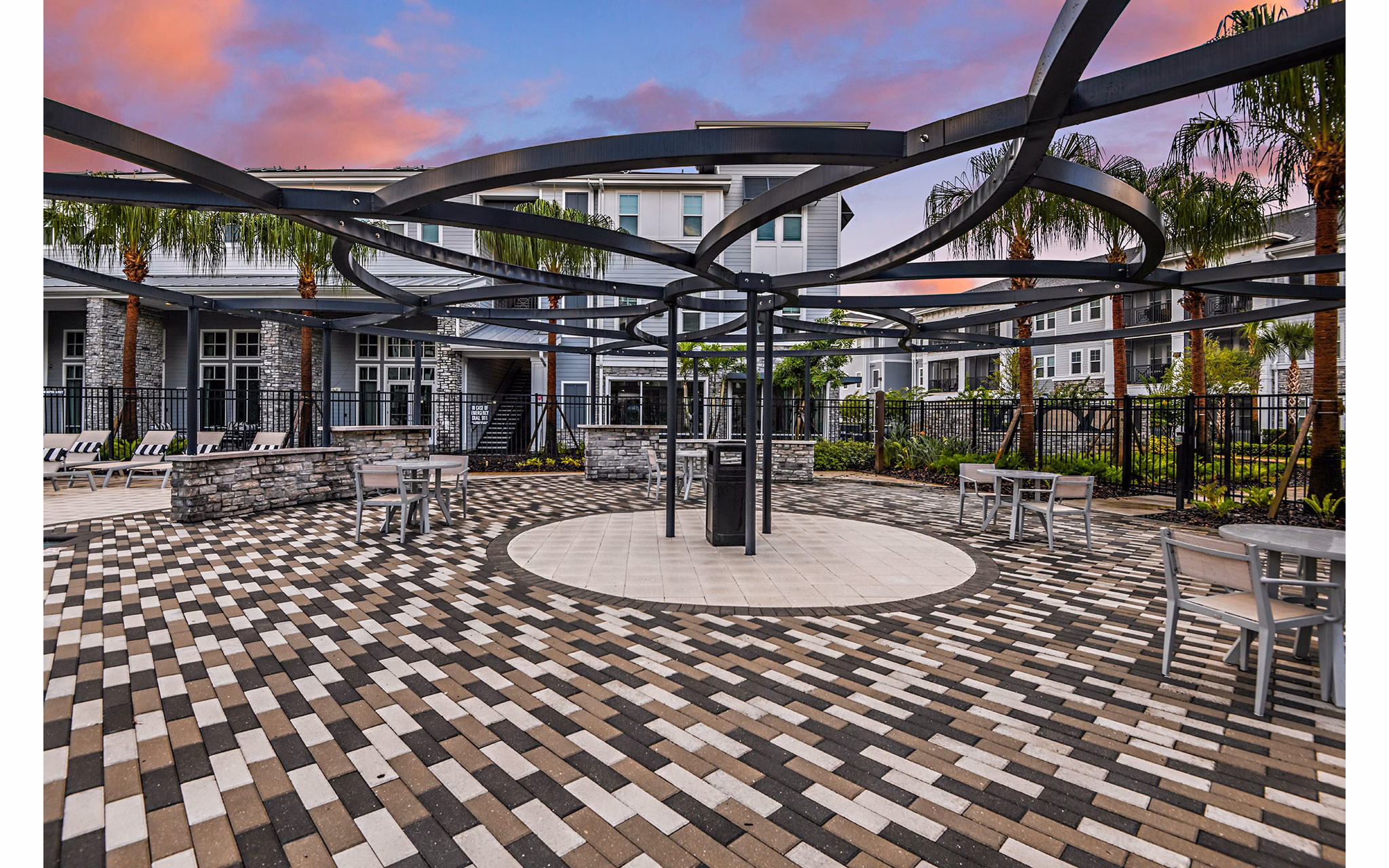 Stylish outdoor patio with cozy seating at Encore Metro at Millenia Apartments, ideal for relaxation and social gatherings
