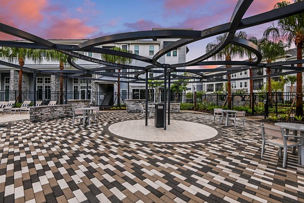 Stylish outdoor patio with cozy seating at Encore Metro at Millenia Apartments, ideal for relaxation and social gatherings