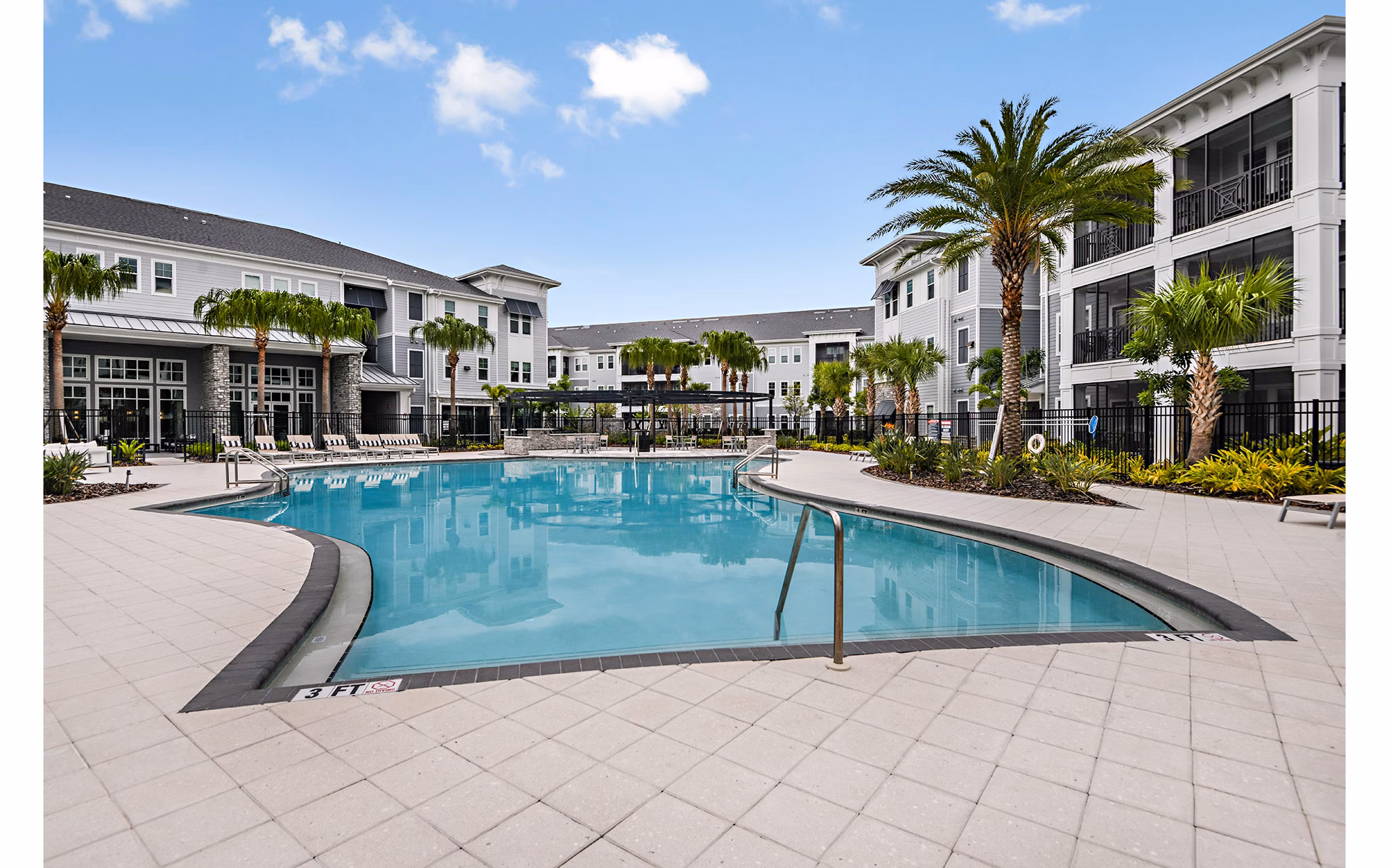 Relaxing pool at Encore Metro at Millenia Apartments surrounded by lush greenery
