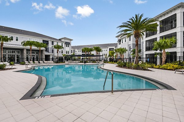 Relaxing pool at Encore Metro at Millenia Apartments surrounded by lush greenery