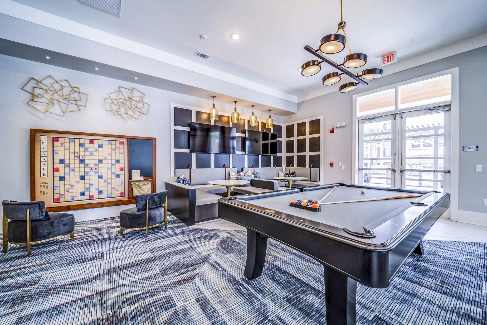 Clubhouse game room with billiards and seating at Residences at Shiloh Crossing Apartments