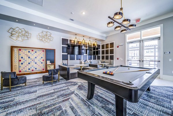 Clubhouse game room with billiards and seating at Residences at Shiloh Crossing Apartments