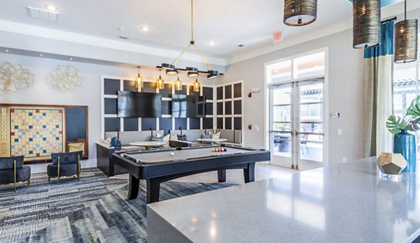 Clubhouse game room with billiards and modern seating at Residences at Shiloh Crossing Apartments