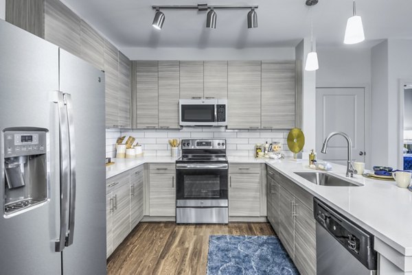 Modern kitchen with stainless steel appliances at Residences at Shiloh Crossing Apartments
