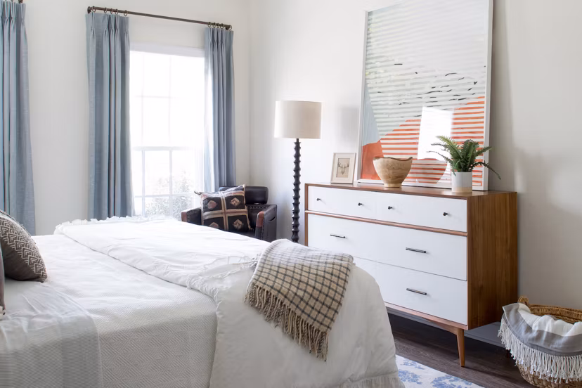 Cozy bedroom with modern decor at Carrington at Schilling Farms Apartments, offering luxury living in a serene setting