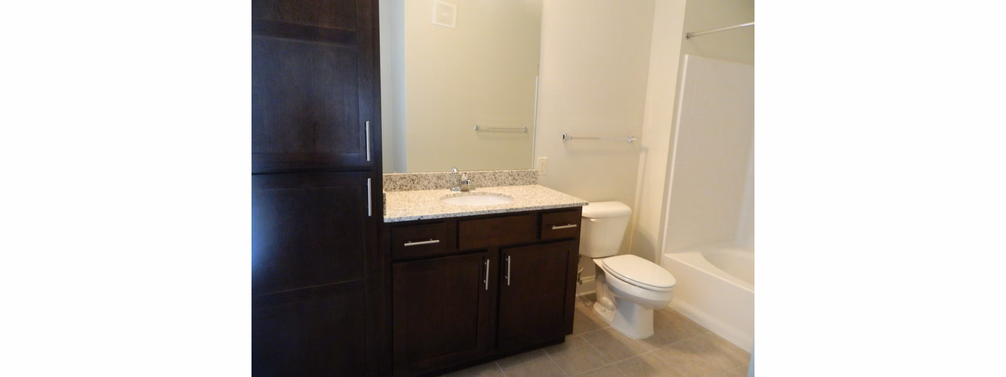Modern bathroom featuring sleek cabinetry and fixtures in Carrington at Schilling Farms Apartments