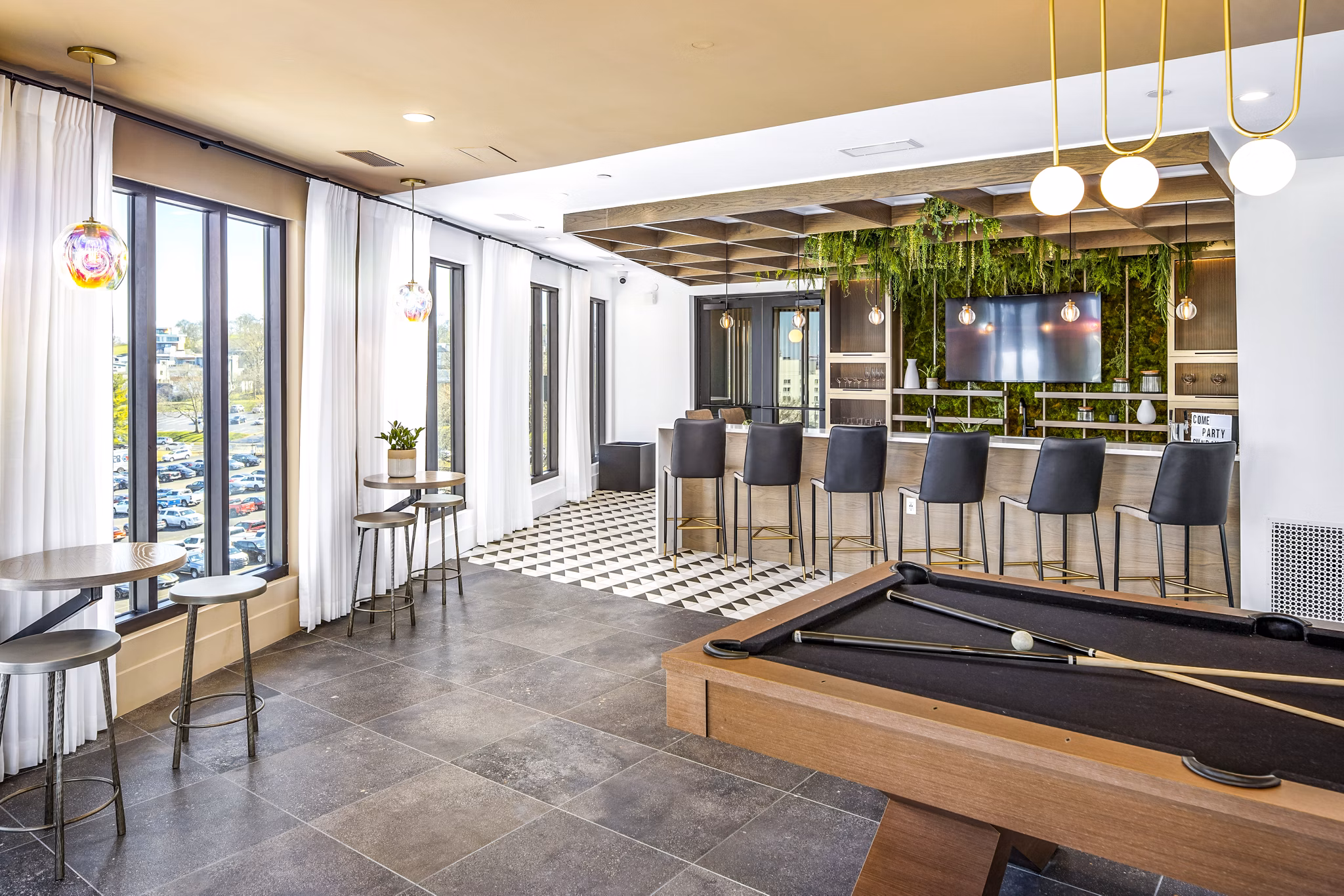 Modern clubhouse at Novel Edgehill Apartments featuring lounge seating and entertainment spaces