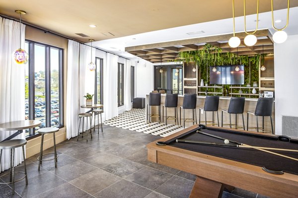Modern clubhouse at Novel Edgehill Apartments featuring lounge seating and entertainment spaces