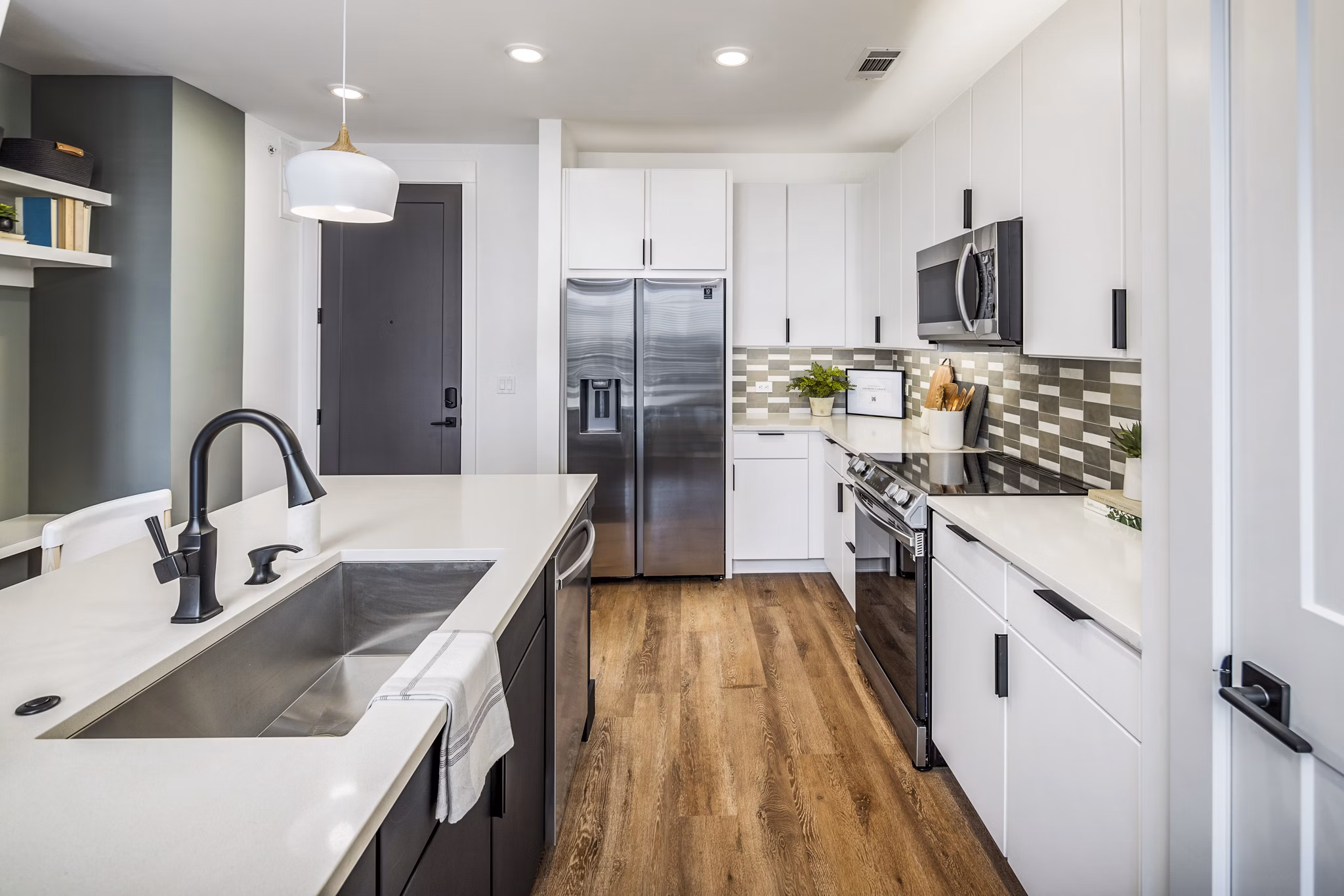 Modern kitchen with stainless steel appliances in Novel Edgehill Apartments
