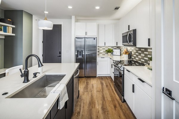 Modern kitchen with stainless steel appliances in Novel Edgehill Apartments