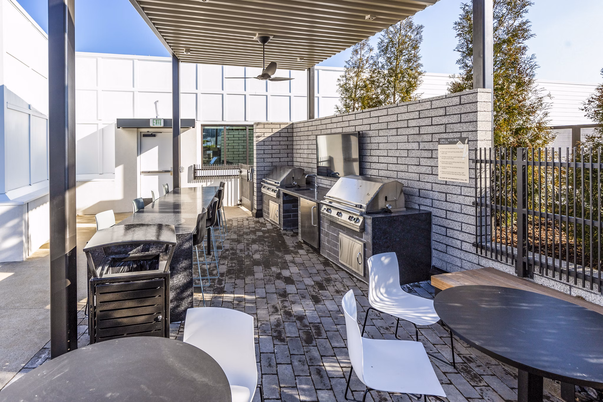 Outdoor grill area with modern seating at Novel Edgehill Apartments, Nashville - ideal for social gatherings and barbecues