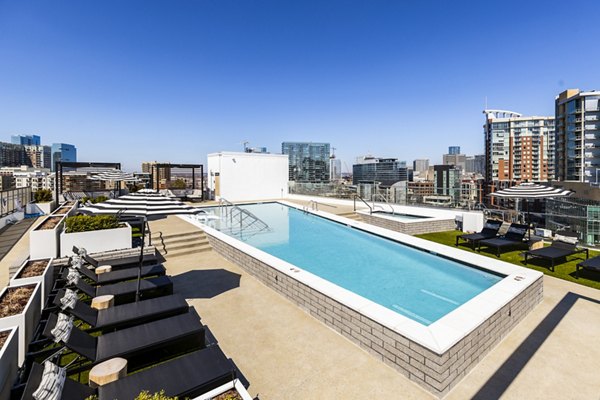 Modern pool area with sun loungers at Novel Edgehill Apartments offering luxury living near Nashville, ideal for relaxation and recreation