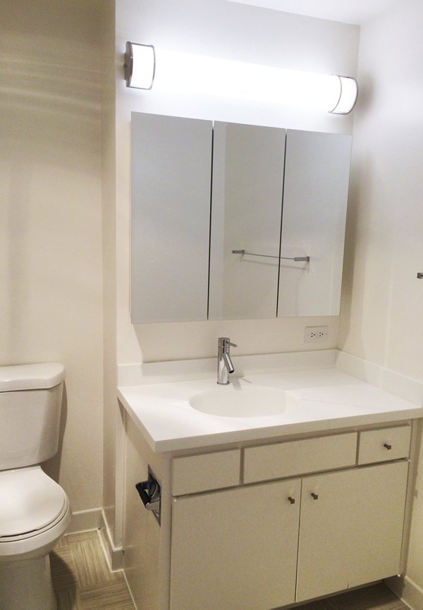 Bathroom featuring modern fixtures and elegant marble tiles at Cathedral Hill Plaza Apartments, a Greystar luxury property
