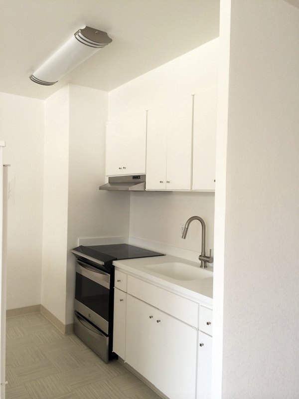 Modern kitchen with stainless steel appliances at Cathedral Hill Plaza Apartments