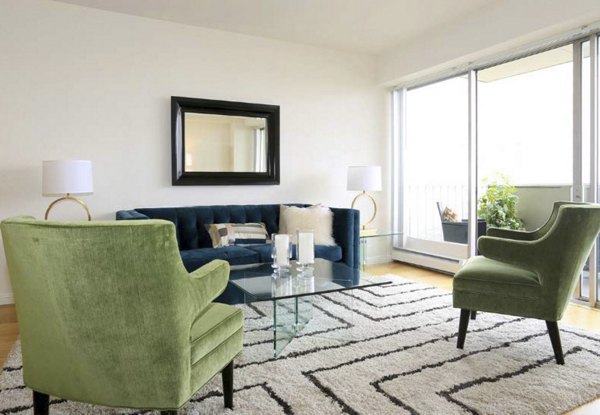 Chic living room with modern decor and large windows at Cathedral Hill Plaza Apartments