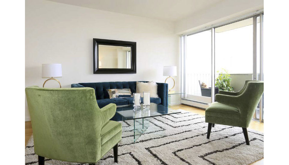 Chic living room with modern decor and large windows at Cathedral Hill Plaza Apartments