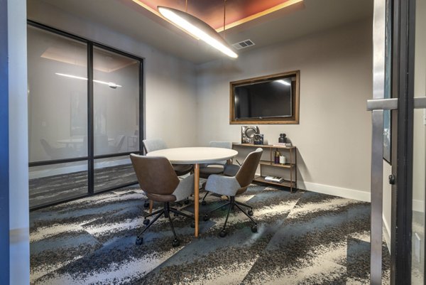 State-of-the-art meeting facility at Alexan Flower Mound Apartments with modern furnishings and AV equipment