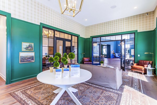 Modern clubhouse with plush seating and fireplace at Town Center at Berry Farms Apartments