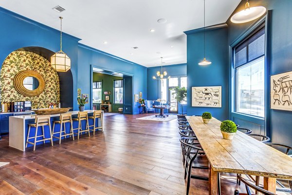 Clubhouse at Town Center at Berry Farms Apartments: Modern design with cozy seating and billiards table, in a luxury apartment setting