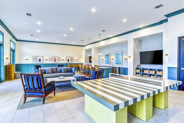 Vibrant clubhouse game room with pool table at Town Center at Berry Farms Apartments offers a relaxing space for residents