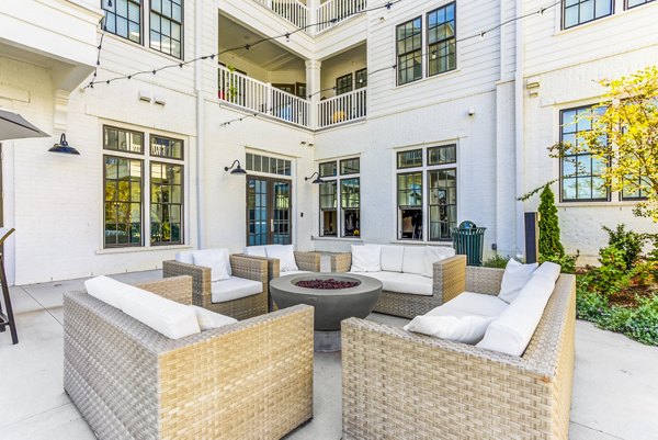 Cozy fire pit patio for relaxing evenings at Town Center at Berry Farms Apartments