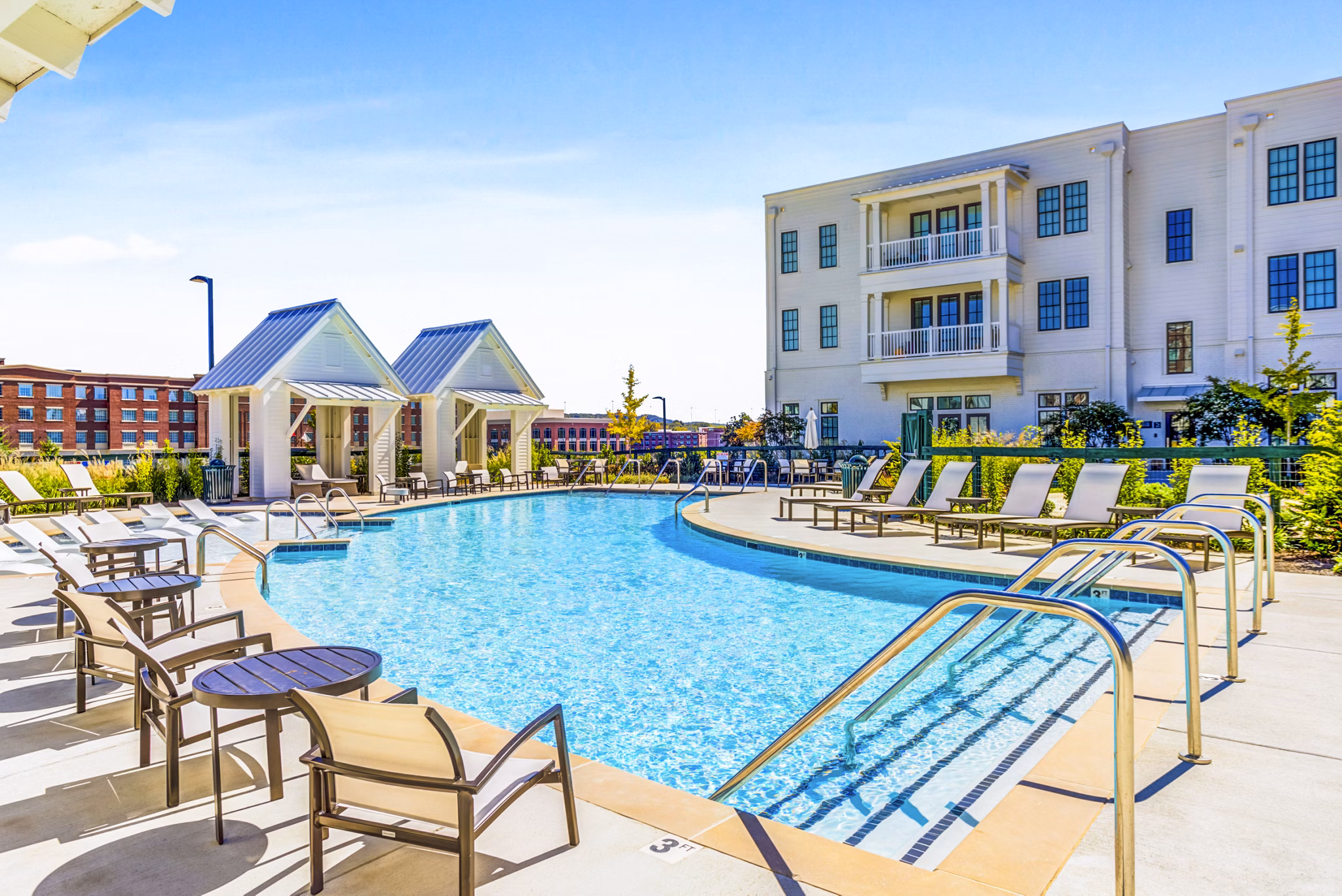 Rooftop pool with lounge chairs at Town Center at Berry Farms Apartments