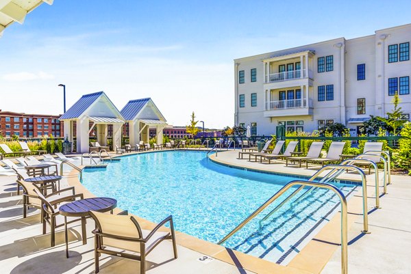 Rooftop pool with lounge chairs at Town Center at Berry Farms Apartments