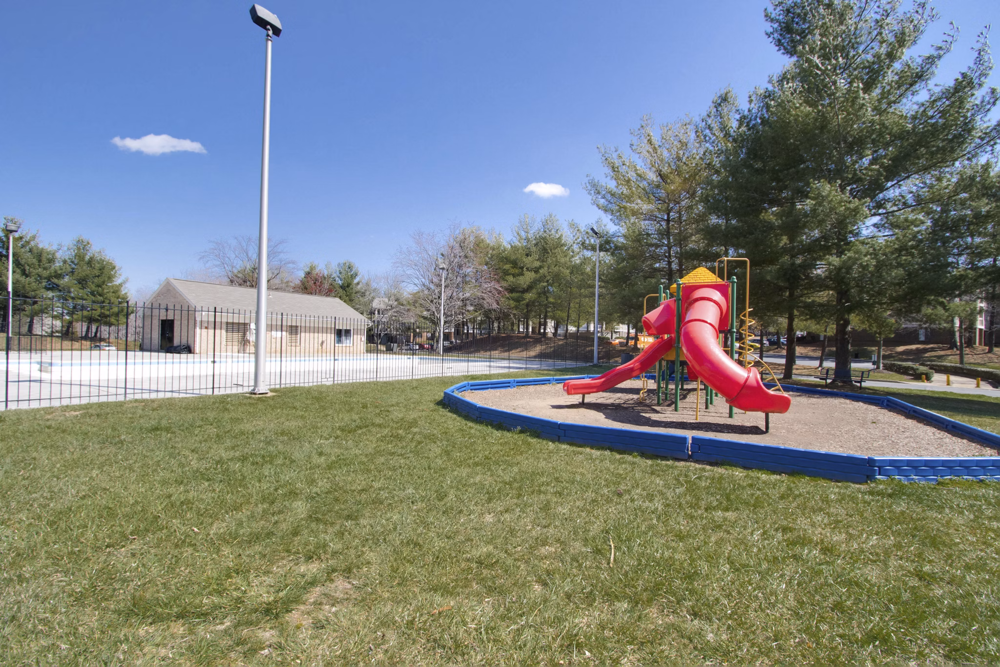 Playground with green spaces at Avana Stoney Ridge Apartments, ideal for outdoor activities and family-friendly living