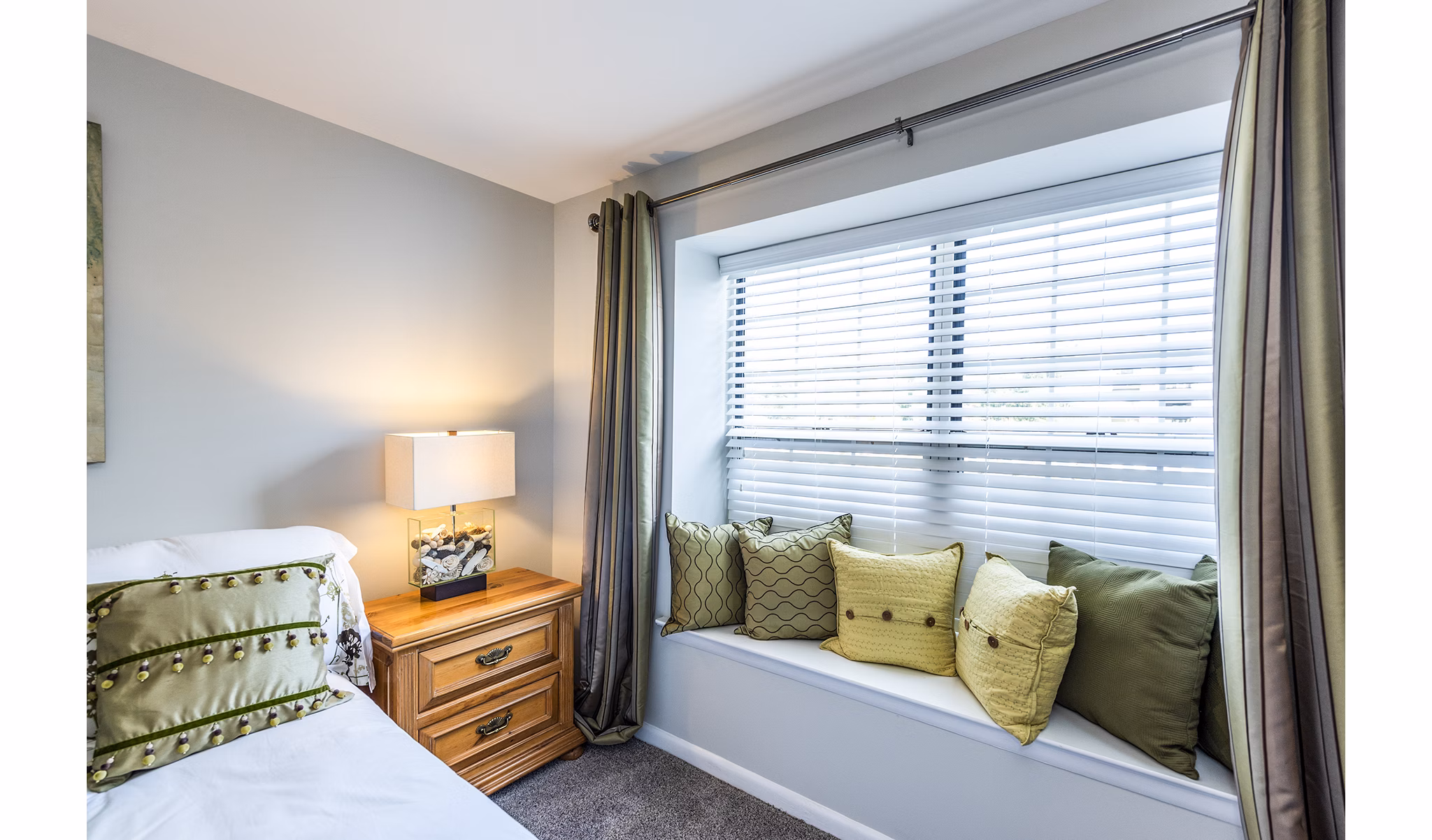 Cozy bedroom with contemporary decor at Ravens Crest Apartments featuring luxury living spaces