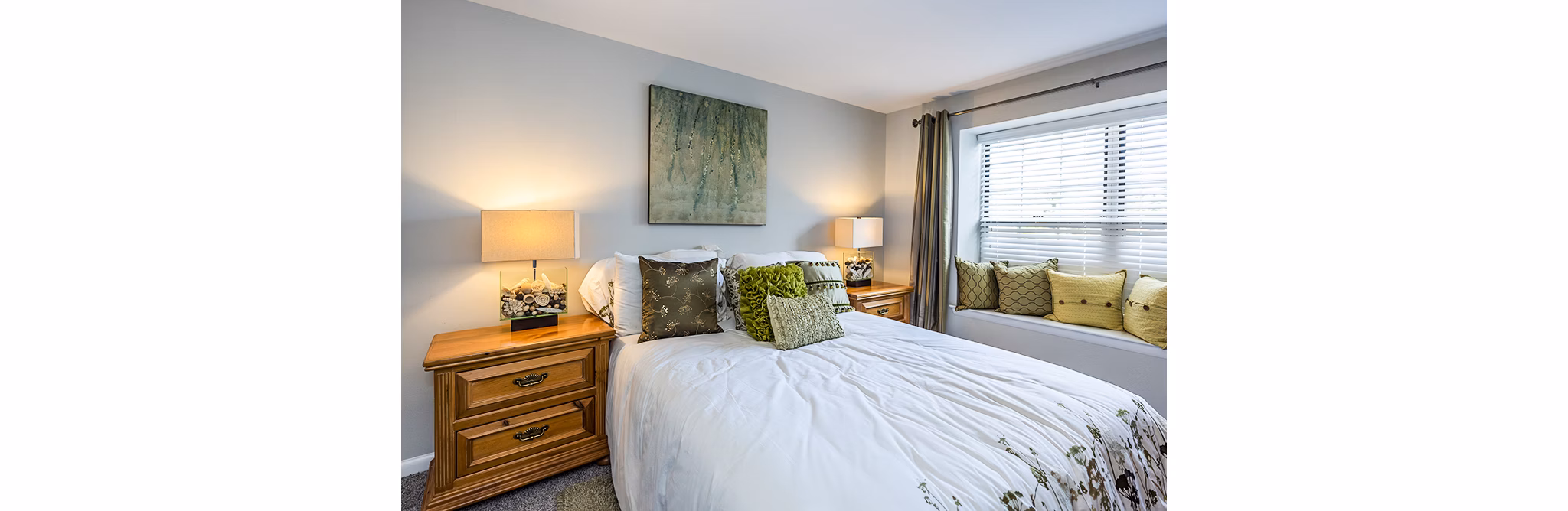 Cozy bedroom with large window at Ravens Crest Apartments, luxury living in a tranquil setting