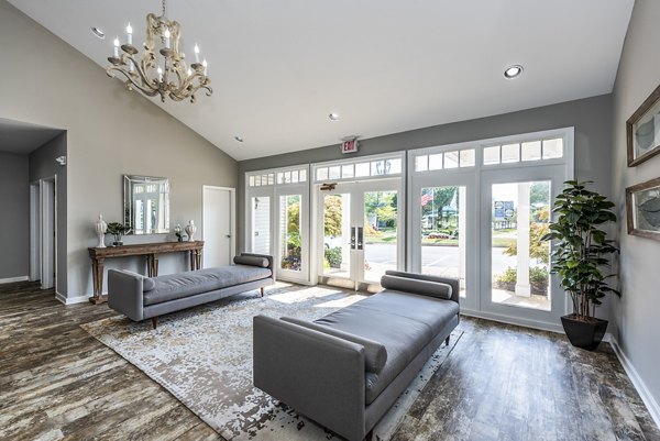 Clubhouse lobby featuring modern seating and art at Ravens Crest Apartments