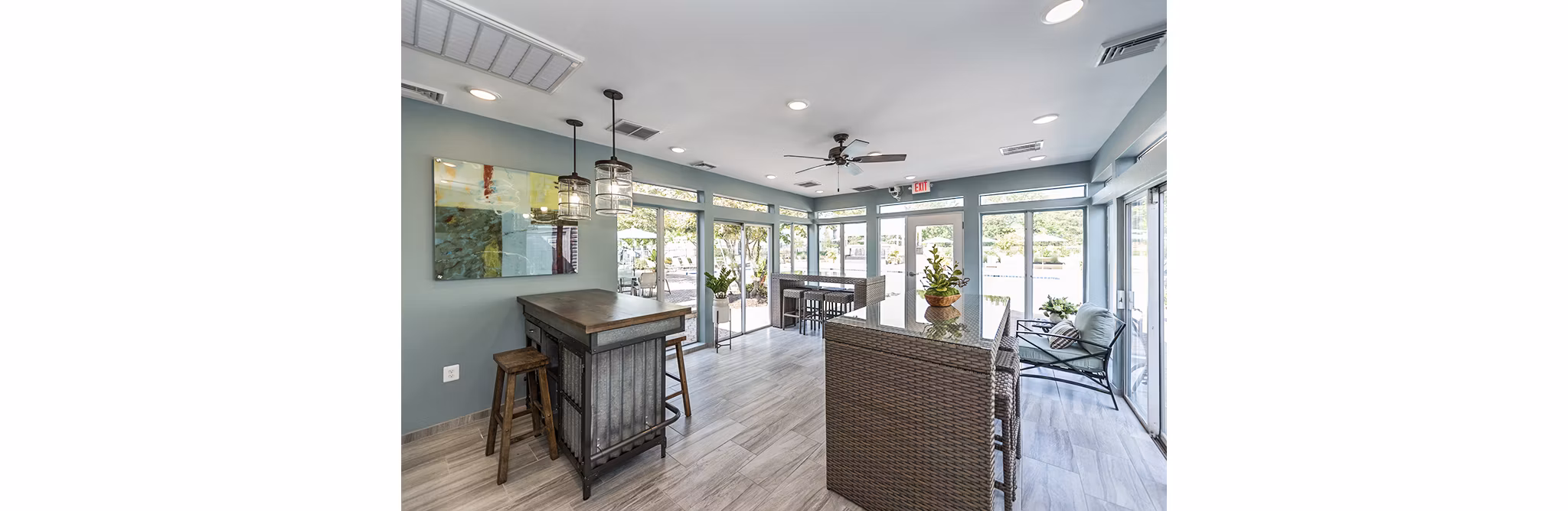 Spacious clubhouse patio with comfortable seating at Ravens Crest Apartments, perfect for outdoor gatherings
