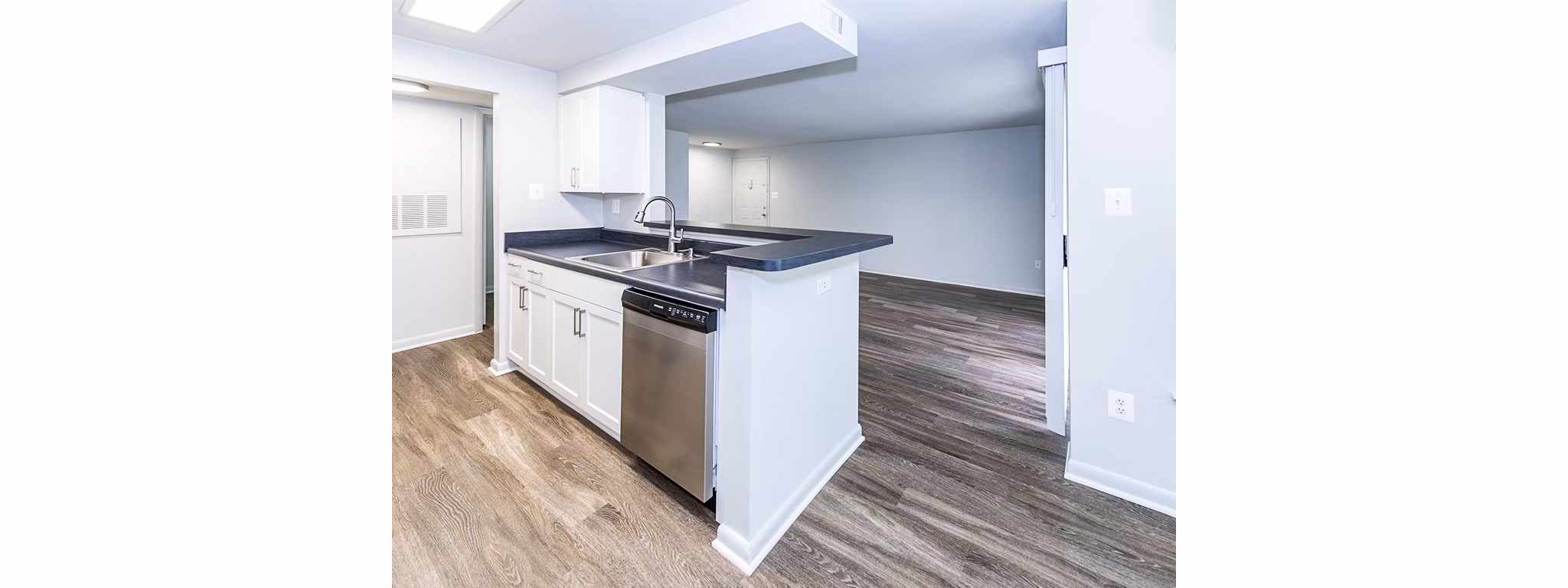 Modern kitchen with stainless steel appliances at Ravens Crest Apartments