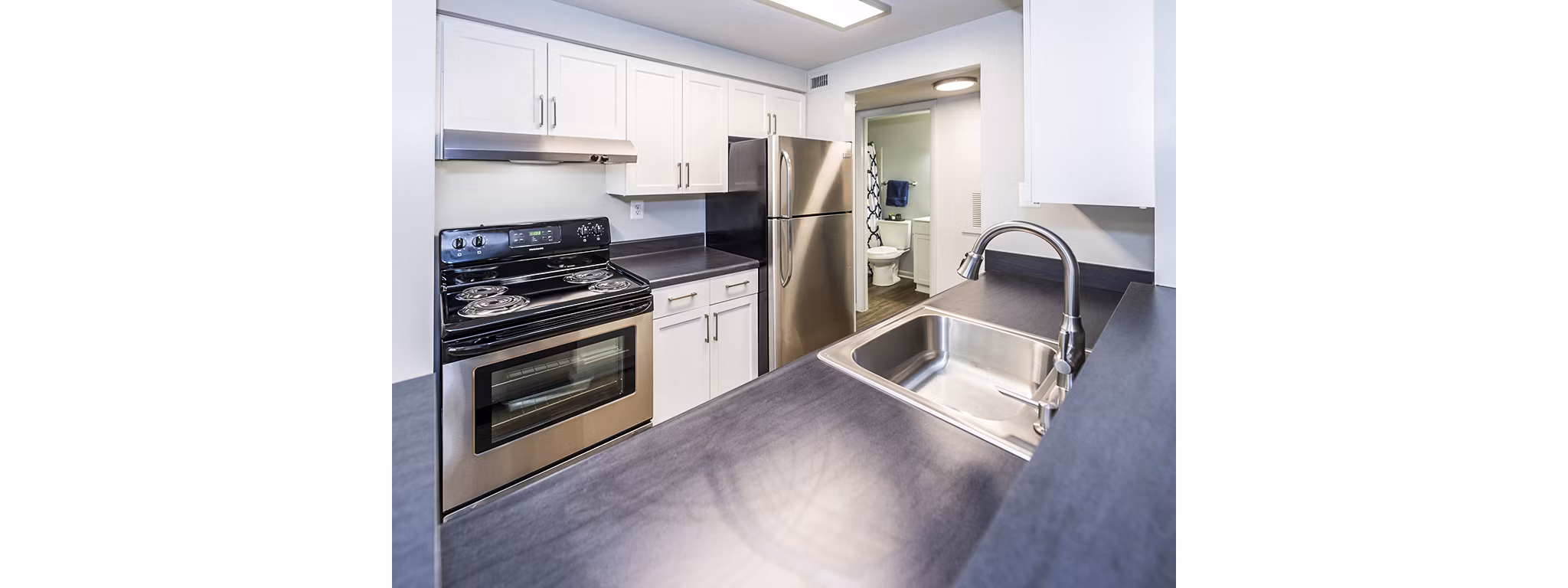 Spacious kitchen featuring modern appliances at Ravens Crest Apartments, a luxury living experience in a serene setting