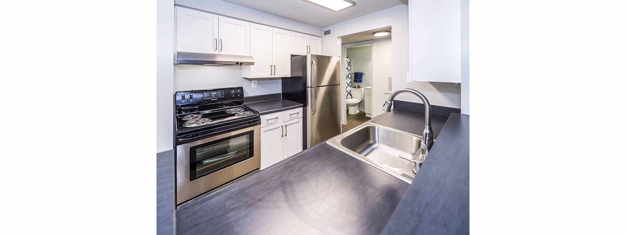 Spacious kitchen featuring modern appliances at Ravens Crest Apartments, a luxury living experience in a serene setting