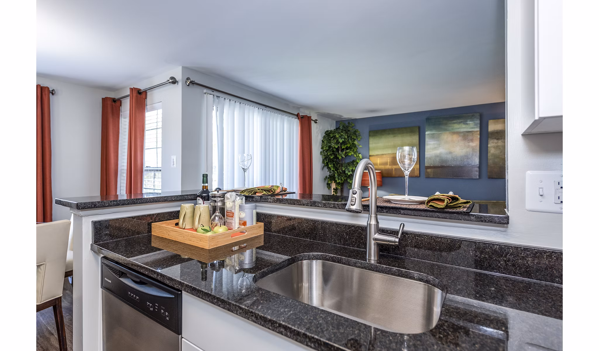 Contemporary kitchen with stainless steel appliances at Ravens Crest Apartments