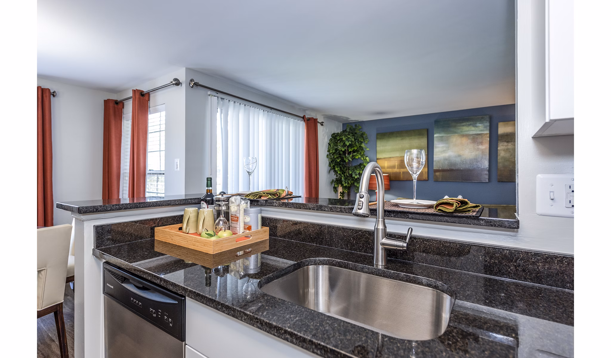 Contemporary kitchen with stainless steel appliances at Ravens Crest Apartments