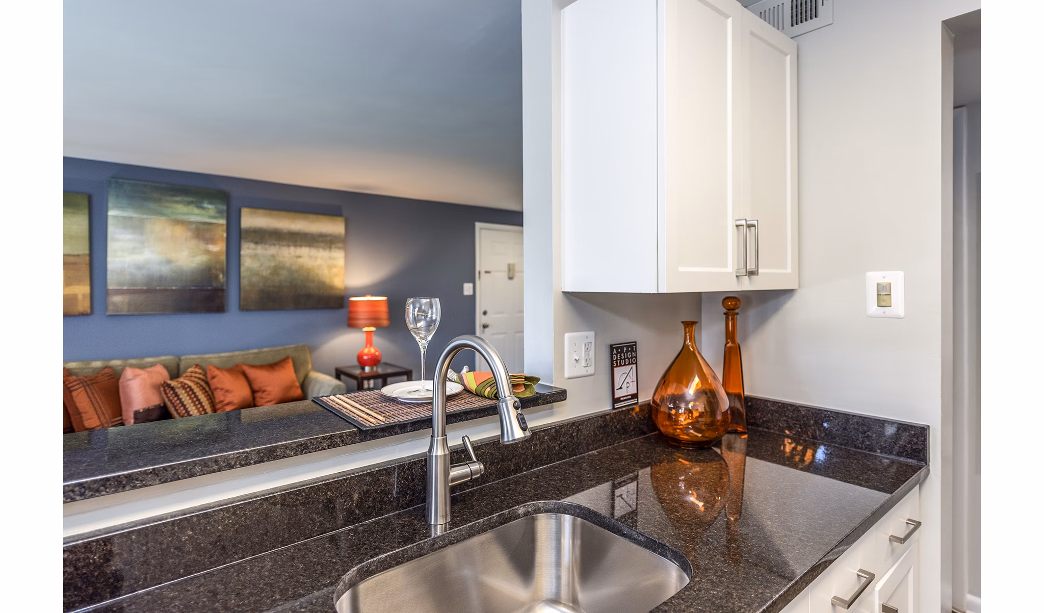 Modern kitchen with stainless steel appliances and granite countertops at Ravens Crest Apartments