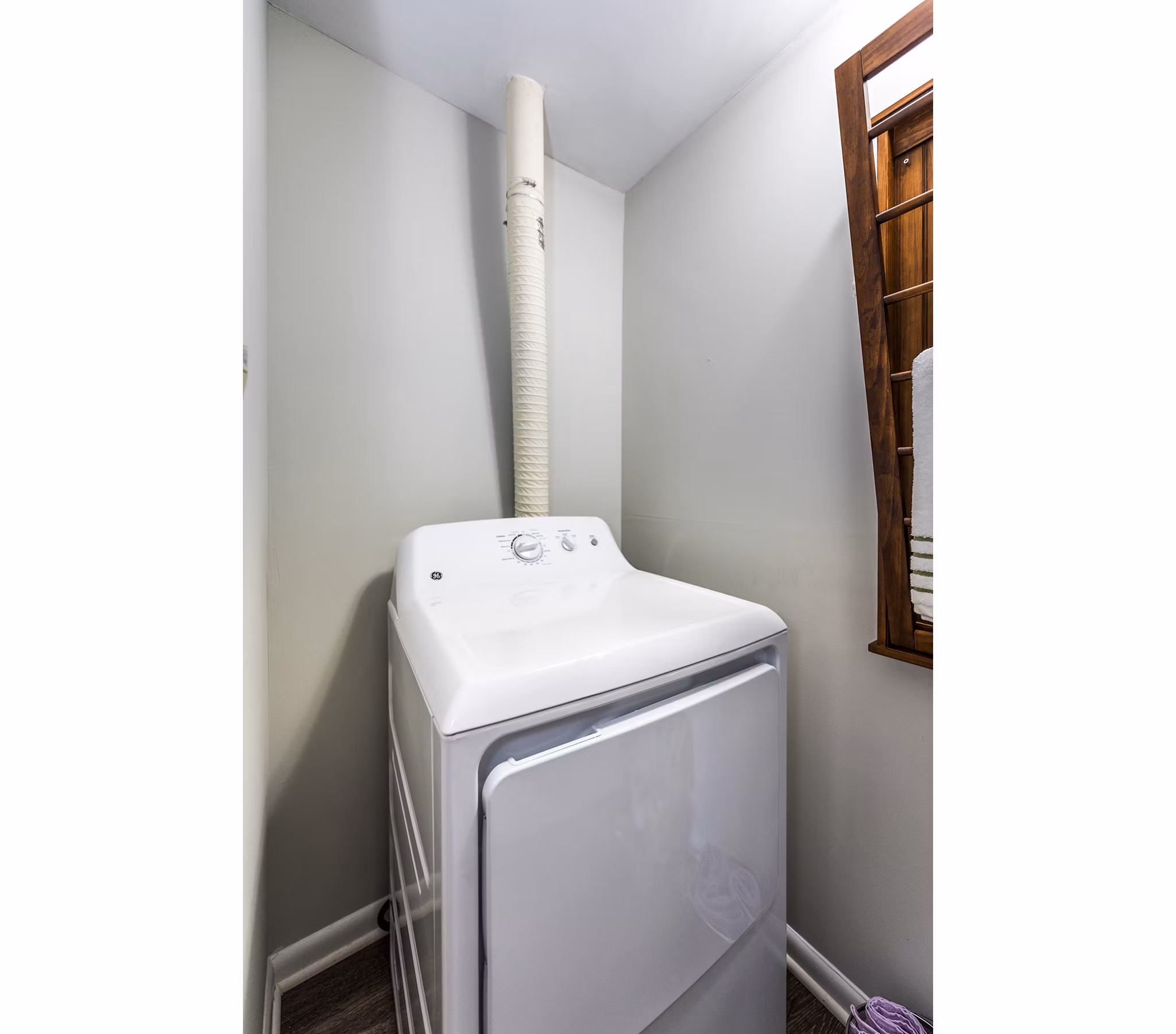 Laundry room featuring modern appliances at Ravens Crest Apartments