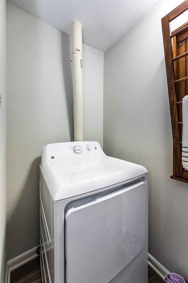 Laundry room featuring modern appliances at Ravens Crest Apartments