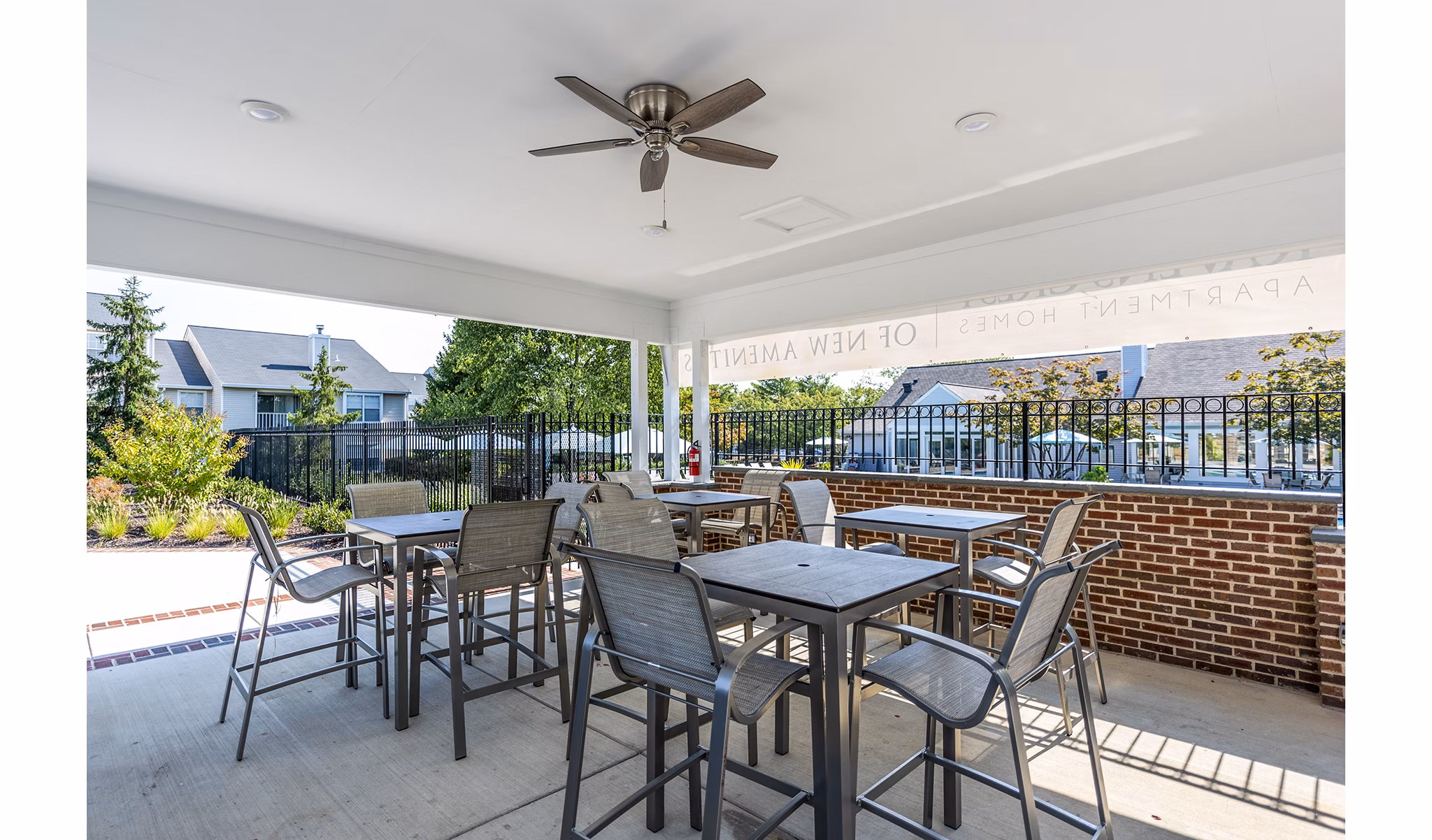 Outdoor pool patio and grill area at Ravens Crest Apartments