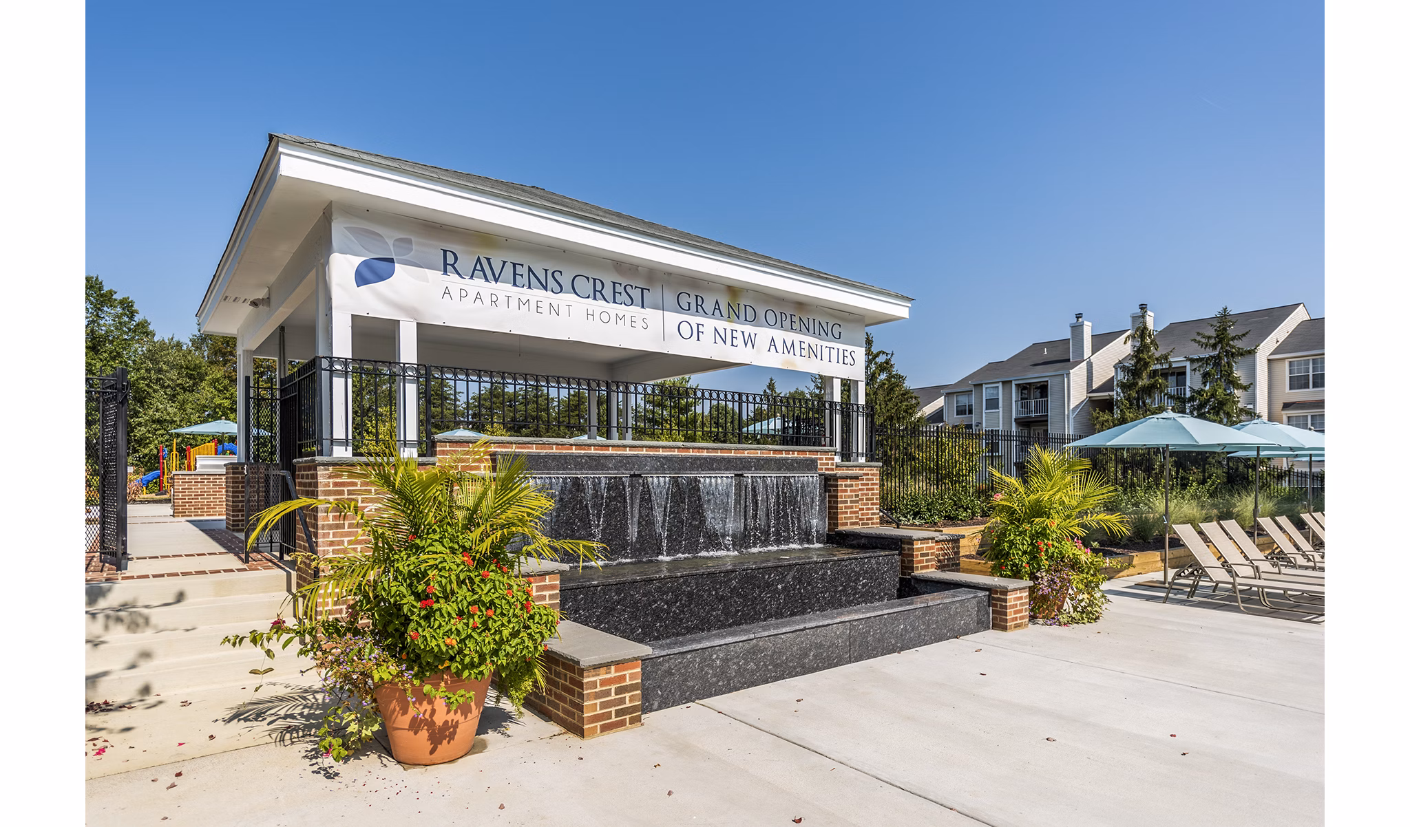 Stunning outdoor pool with loungers at Ravens Crest Apartments, offering luxury living