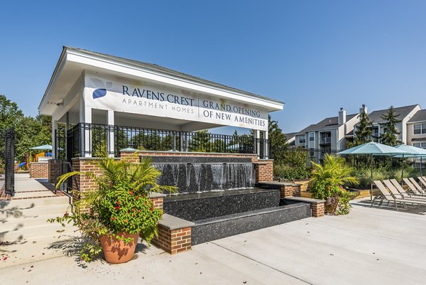 Stunning outdoor pool with loungers at Ravens Crest Apartments, offering luxury living