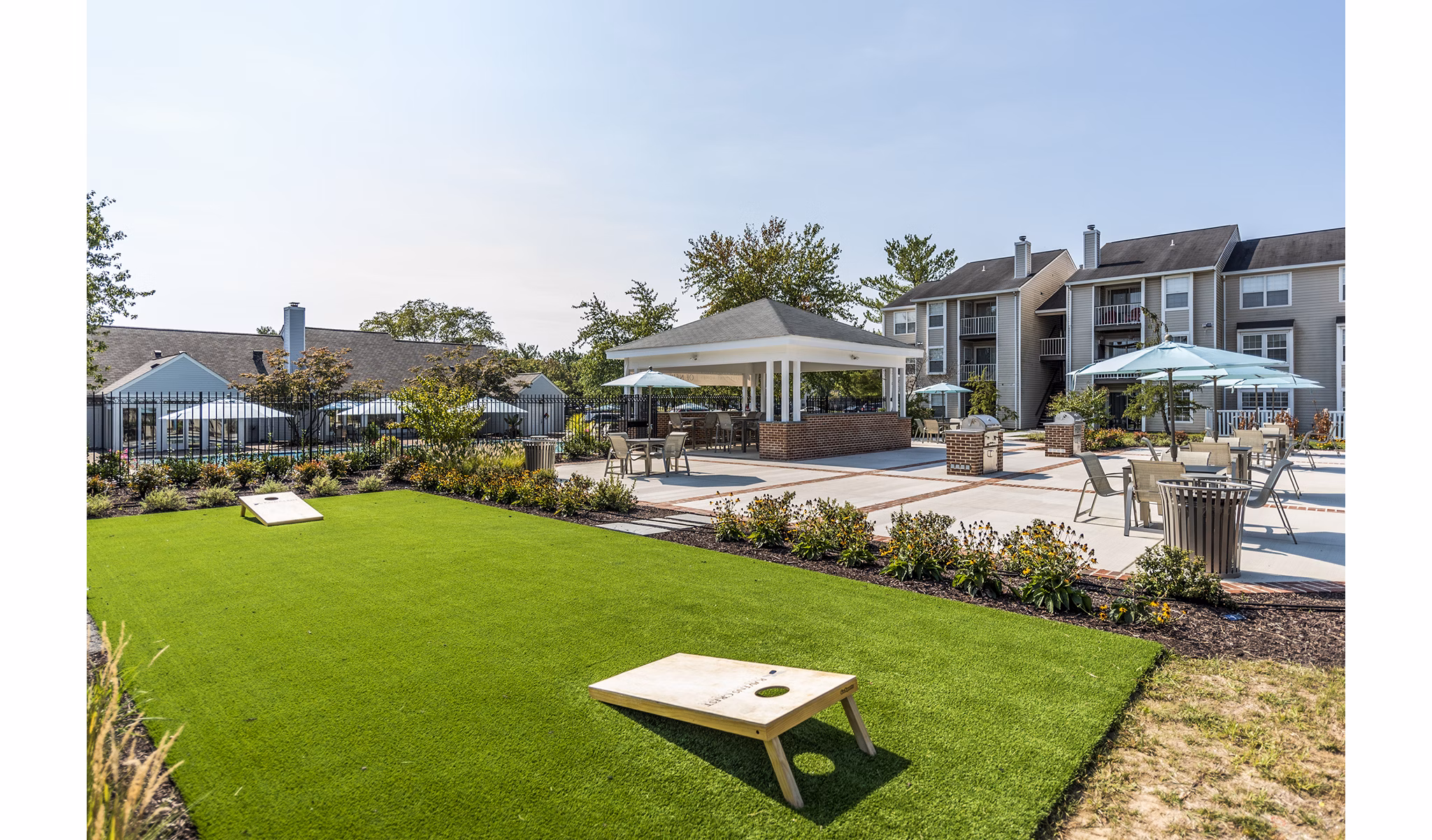 Modern recreational area with tennis courts and picnic spots at Ravens Crest Apartments, catering to active lifestyles in pursuit of leisure and fitness