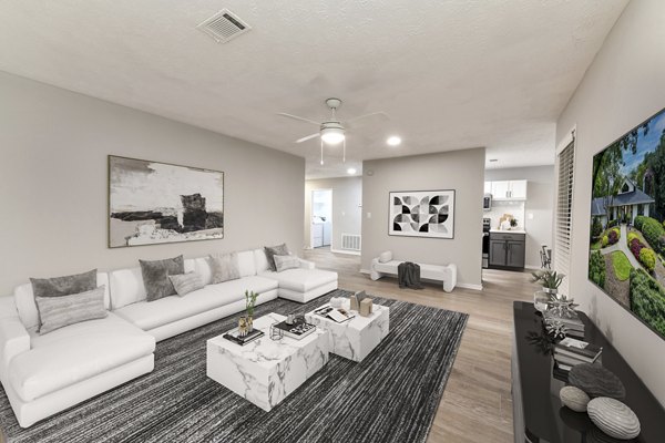 Spacious living room with modern decor and large windows at Avana Chase Apartments