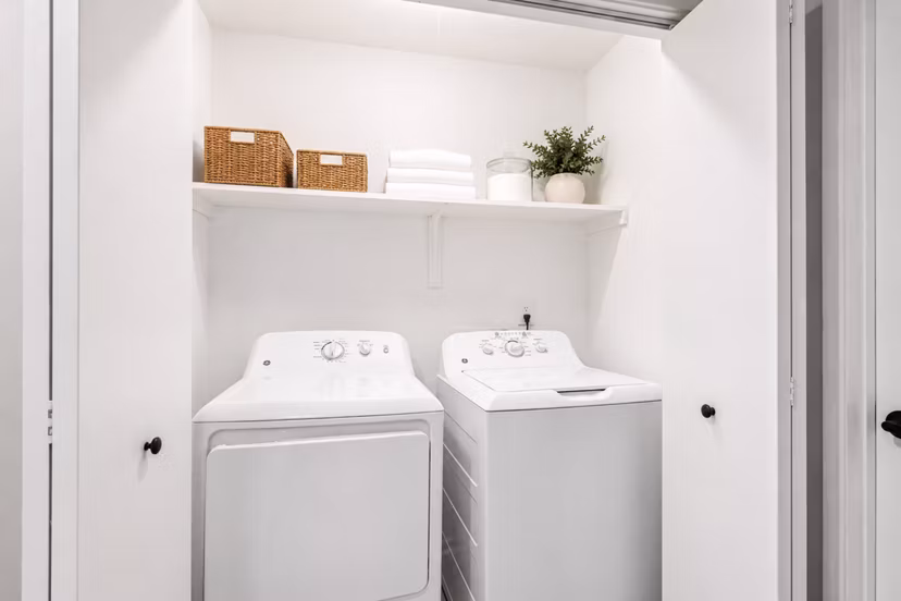 Laundry room with modern washers and dryers at Avana Chase Apartments, a Greystar community