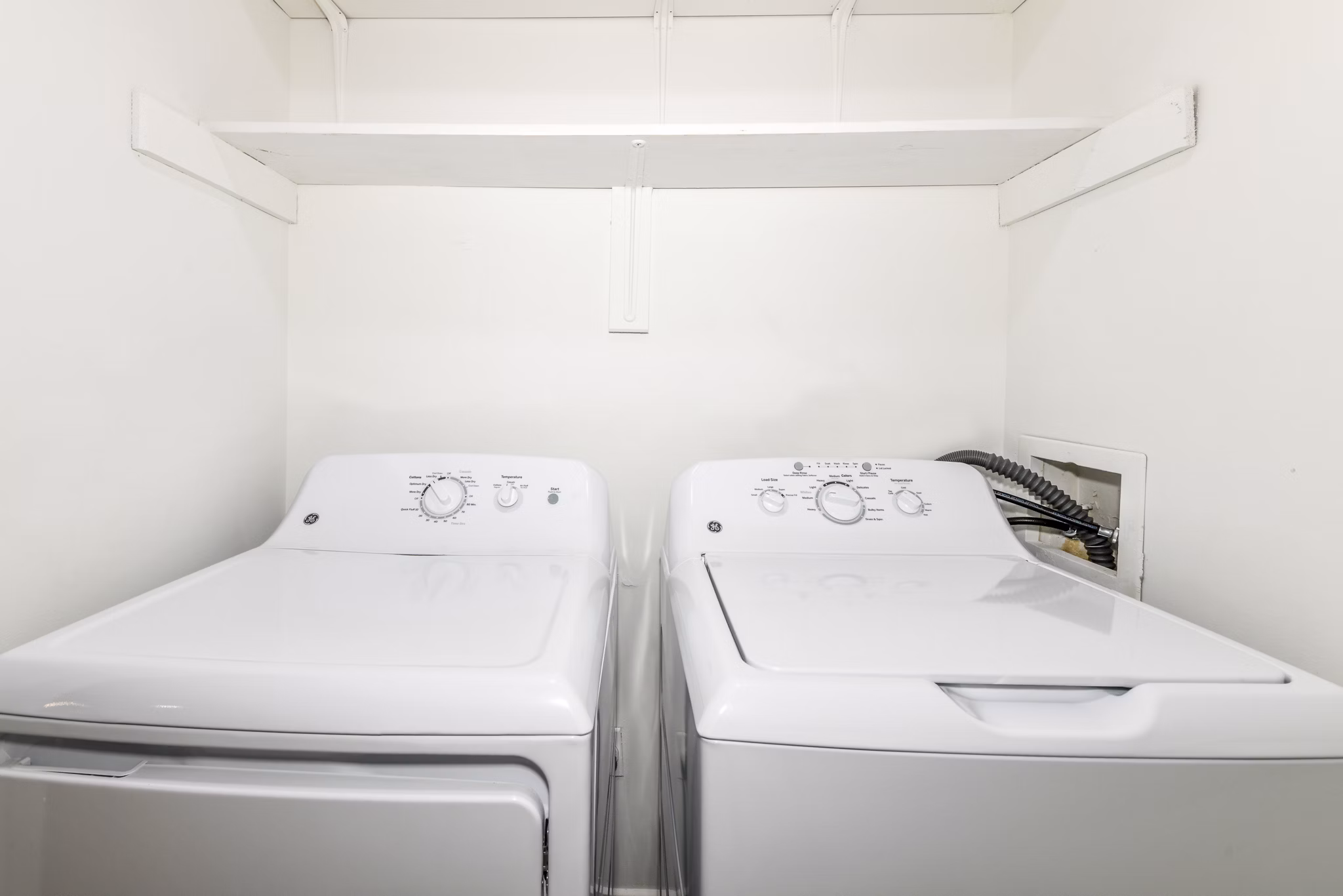 Laundry room with modern washers and dryers at Avana Chase Apartments, a Greystar community