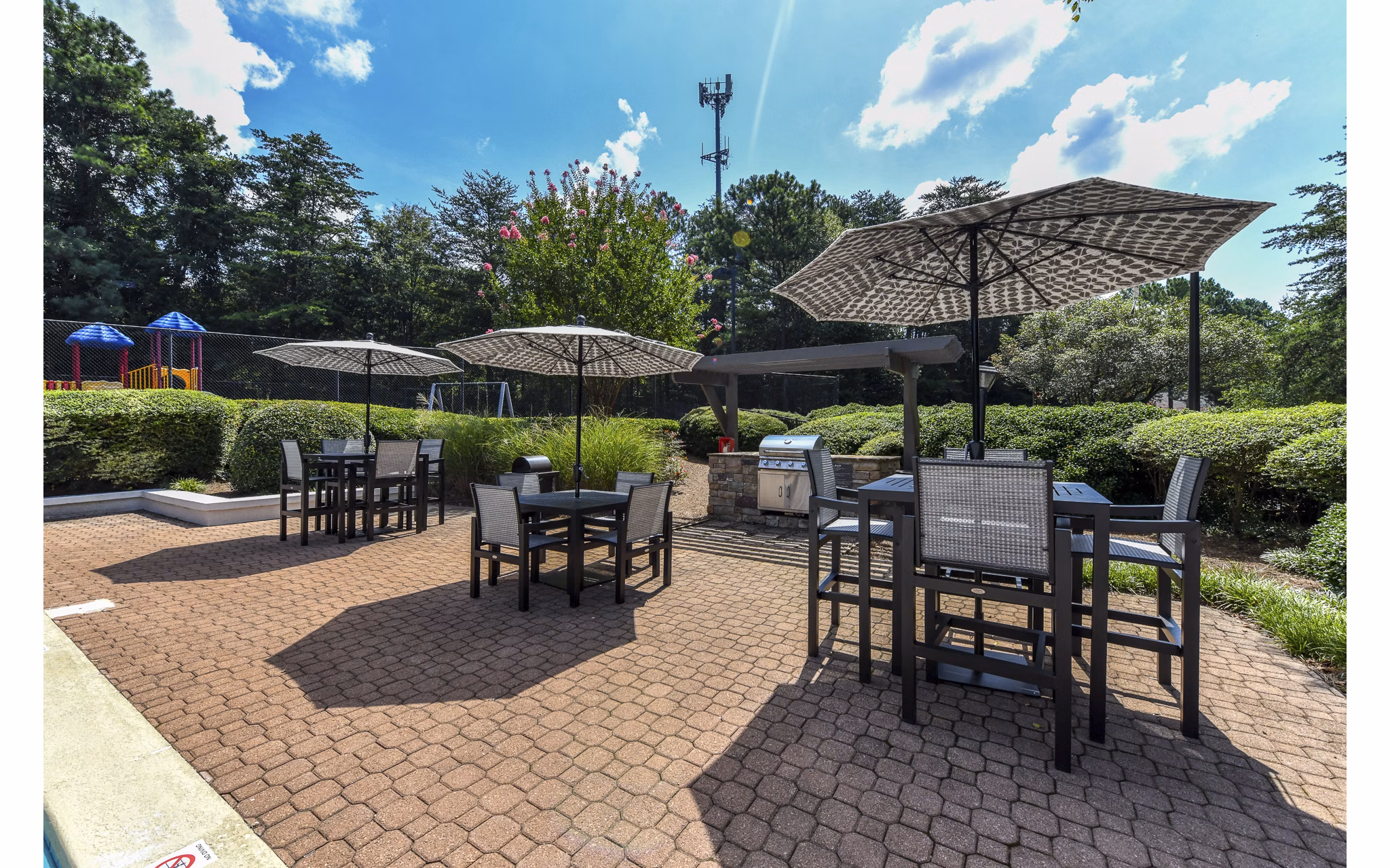Charming outdoor patio with cozy seating area at Avana Chase Apartments