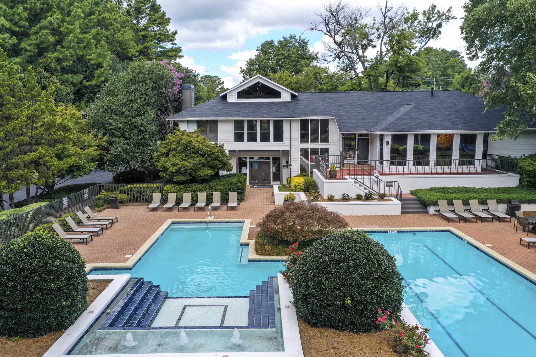 Outdoor pool surrounded by lush greenery at Avana Chase Apartments perfect for relaxation and recreation