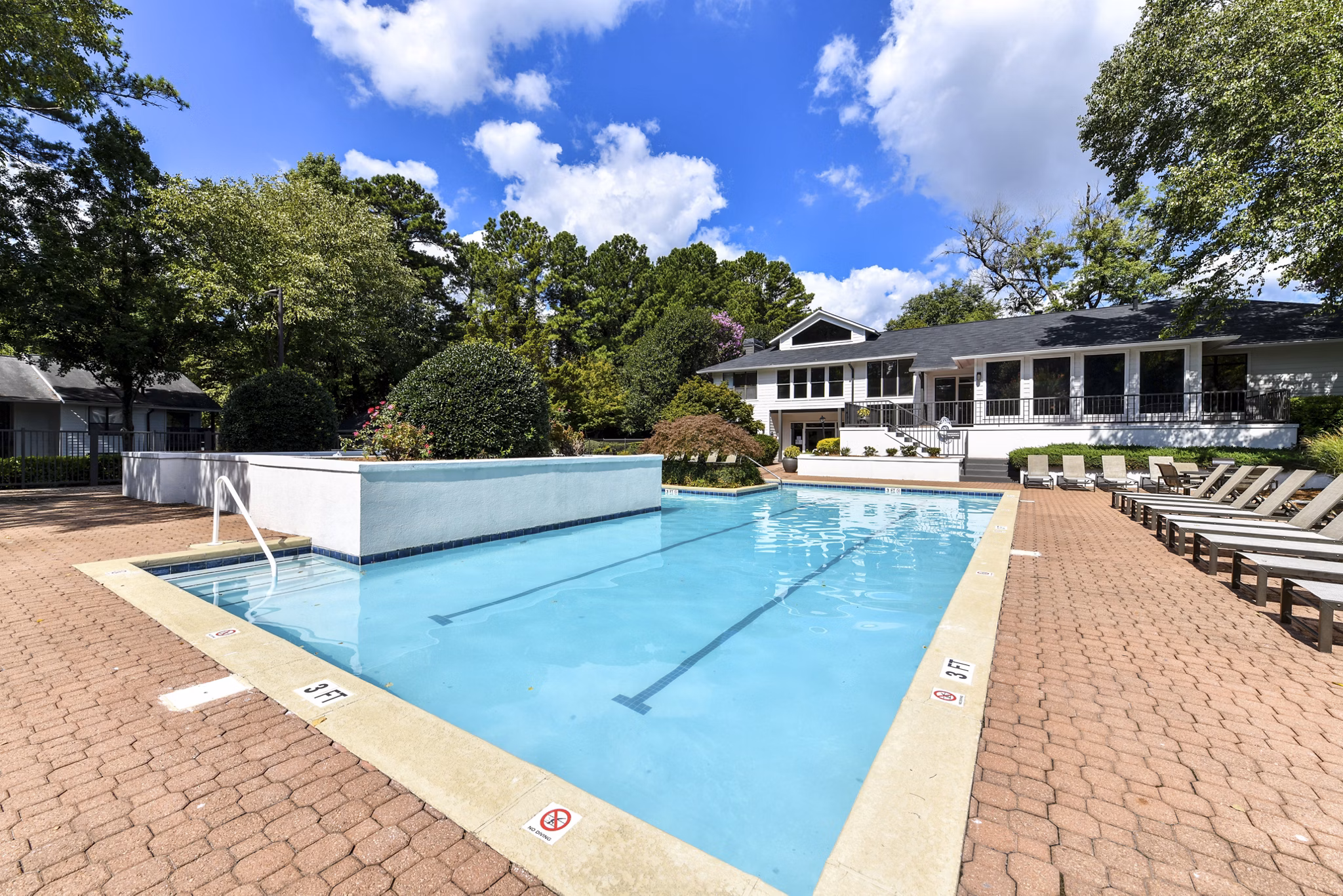 Luxurious poolside retreat with lounge chairs and umbrellas at Avana Chase Apartments